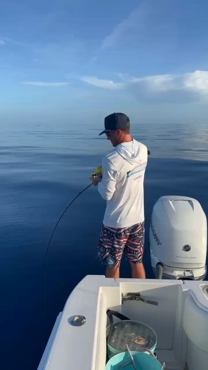Angler working a fish off the gunwale