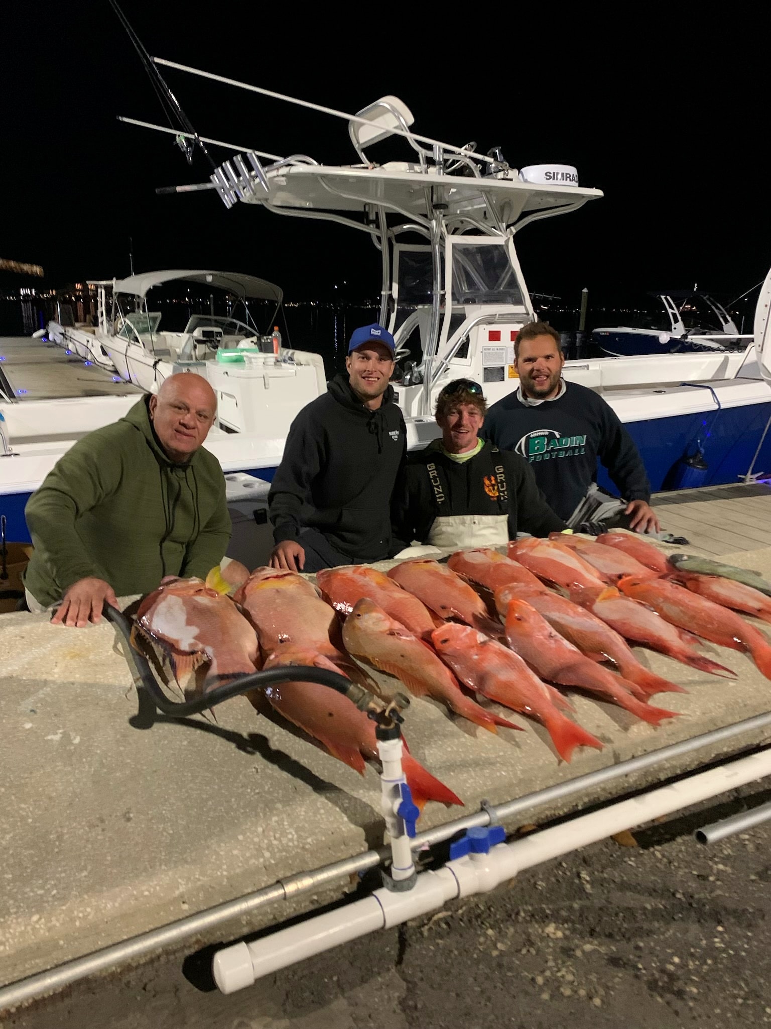 A charter group behind the day's spread of red snapper at the dock