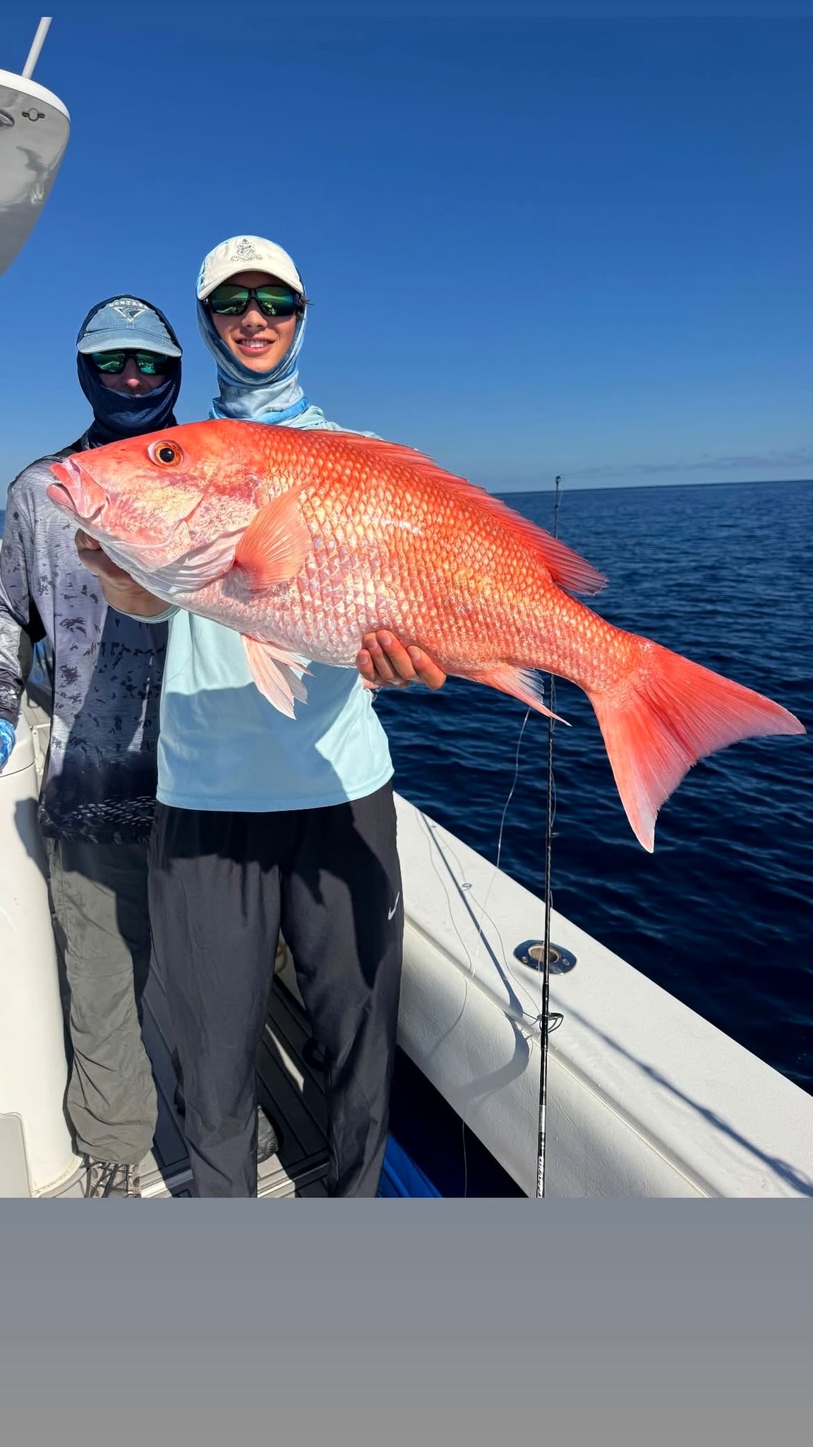 Red snapper held up with the crew behind